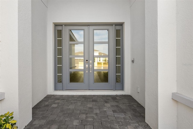 view of exterior entry featuring french doors