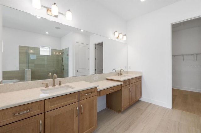 bathroom with vanity and a shower with shower door