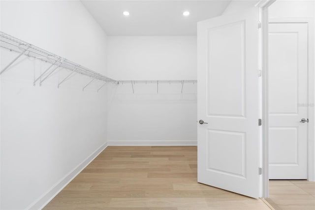 walk in closet with light wood-type flooring