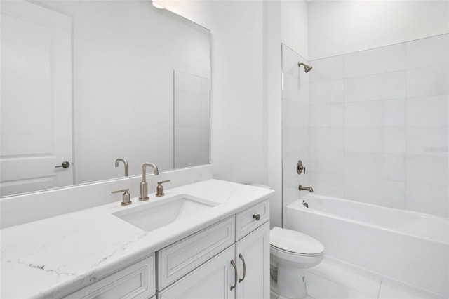 full bathroom featuring tile patterned floors, toilet, vanity, and tiled shower / bath