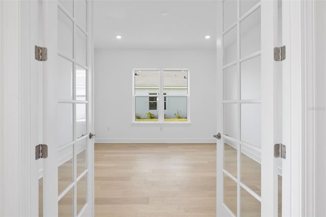 interior space with light wood-type flooring and french doors