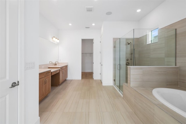 bathroom featuring vanity and plus walk in shower