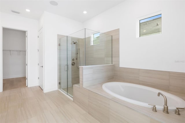 bathroom with shower with separate bathtub