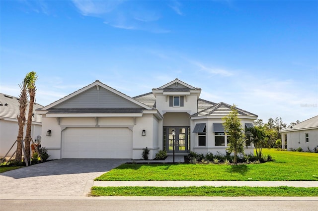 view of front of property featuring a garage, a front yard, and french doors