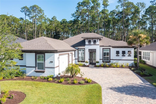 view of front of property featuring a garage and a front lawn