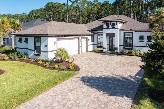 view of front of home with a front yard and a garage