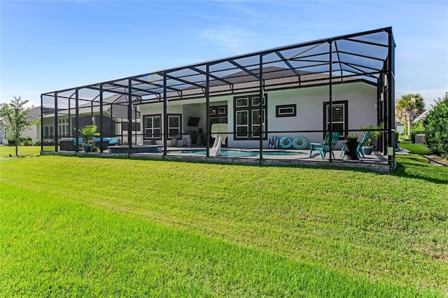 rear view of house featuring a lanai, a yard, and a patio