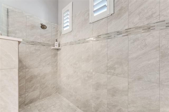 interior details featuring a tile shower