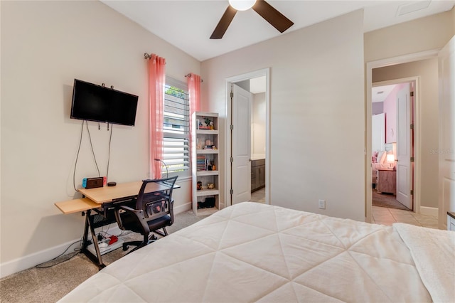 bedroom with light carpet, ensuite bathroom, and ceiling fan