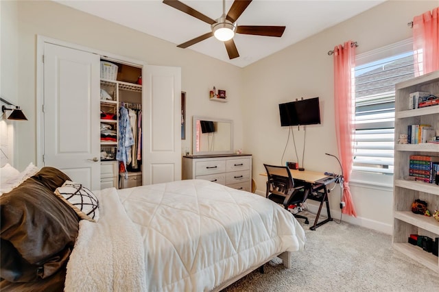 carpeted bedroom with ceiling fan and a closet