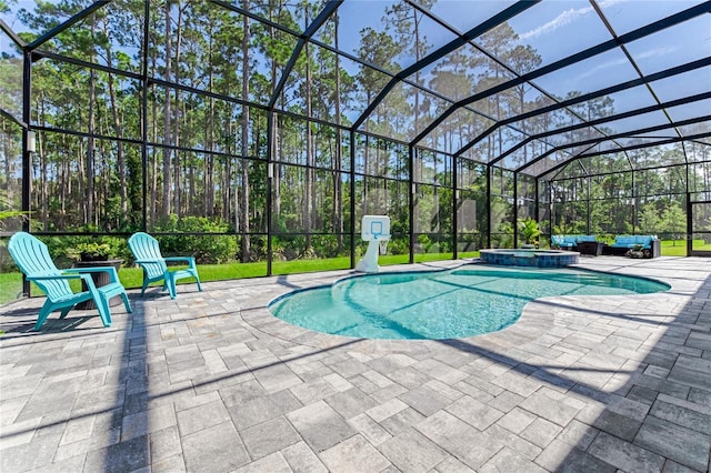 view of pool with glass enclosure, an in ground hot tub, and a patio