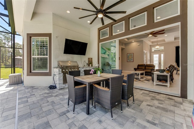 dining room with french doors, a towering ceiling, and ceiling fan with notable chandelier