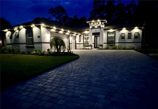 view of front of property with a yard and a garage