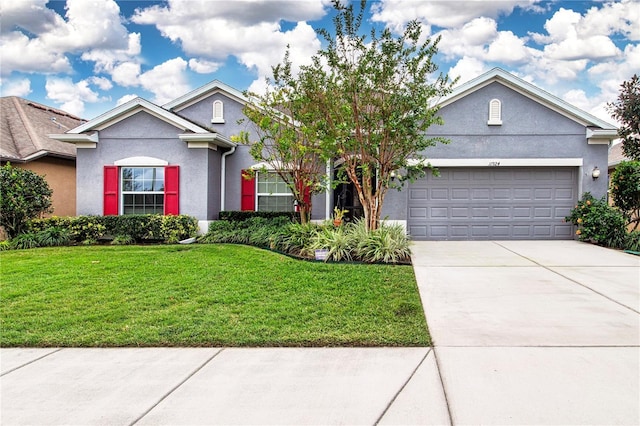 view of front of house featuring a garage and a front lawn