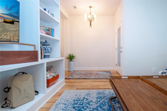 entryway with a chandelier and light hardwood / wood-style floors