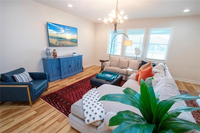 living room featuring light hardwood / wood-style floors and an inviting chandelier