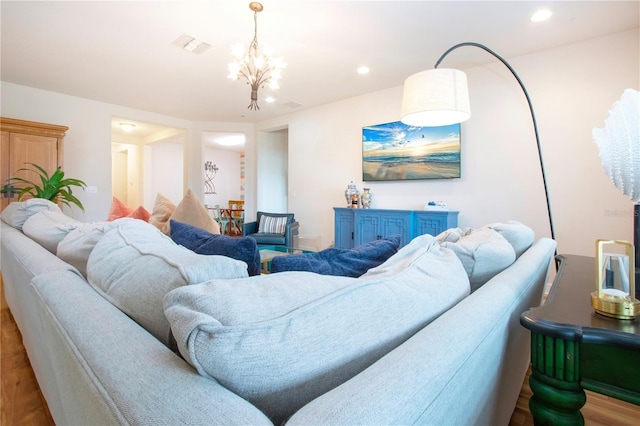 living room featuring a chandelier and wood-type flooring