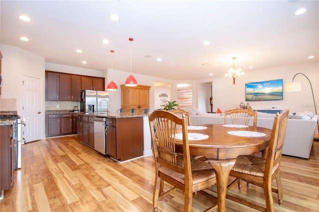 dining room with a chandelier and light hardwood / wood-style floors