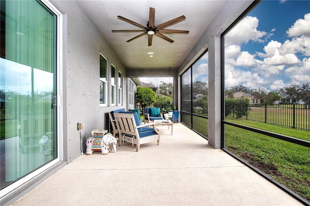 sunroom featuring ceiling fan