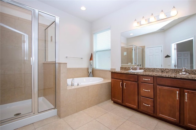 bathroom with tile patterned flooring, vanity, and separate shower and tub