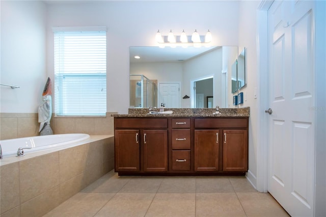 bathroom featuring tile patterned flooring, vanity, and separate shower and tub