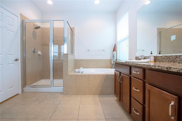 bathroom with tile patterned floors, vanity, and separate shower and tub