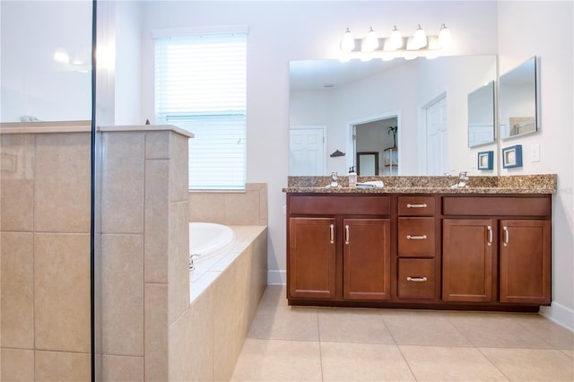 bathroom featuring vanity, tile patterned floors, and tiled tub