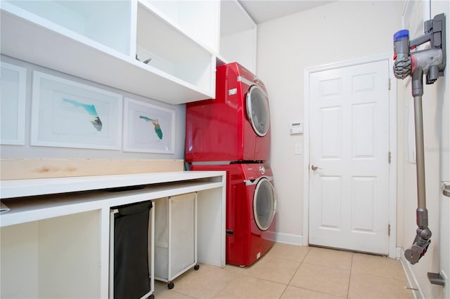 laundry area with stacked washer and dryer and light tile patterned flooring