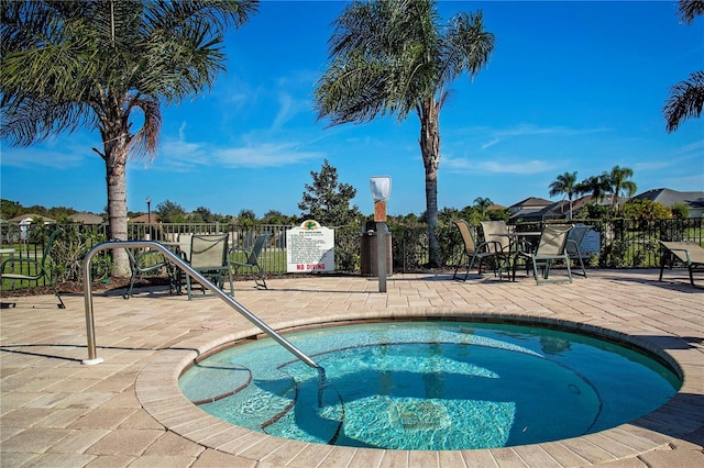 view of swimming pool with a community hot tub and a patio area