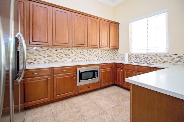 kitchen with backsplash, sink, and appliances with stainless steel finishes