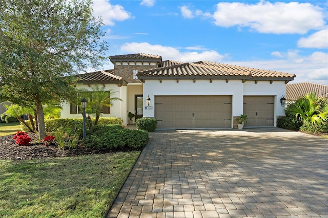 13126 Indigo Way, Bradenton, FL 34211 - mediterranean / spanish house featuring a garage, a tiled roof, decorative driveway, and stucco siding