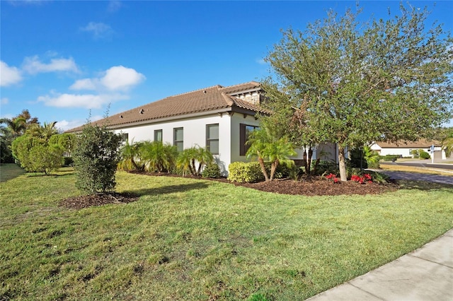 13126 Indigo Way, Bradenton, FL 34211 - view of home's exterior featuring a tiled roof, stucco siding, and a yard