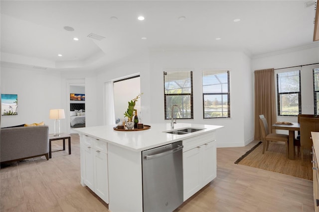 kitchen featuring white cabinetry, stainless steel dishwasher, a kitchen island with sink, and light hardwood / wood-style flooring