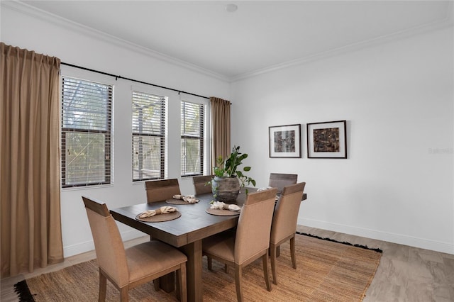 dining room featuring light hardwood / wood-style flooring and ornamental molding