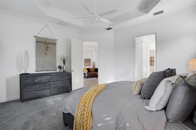 bedroom featuring carpet flooring, a raised ceiling, ceiling fan, and ornamental molding