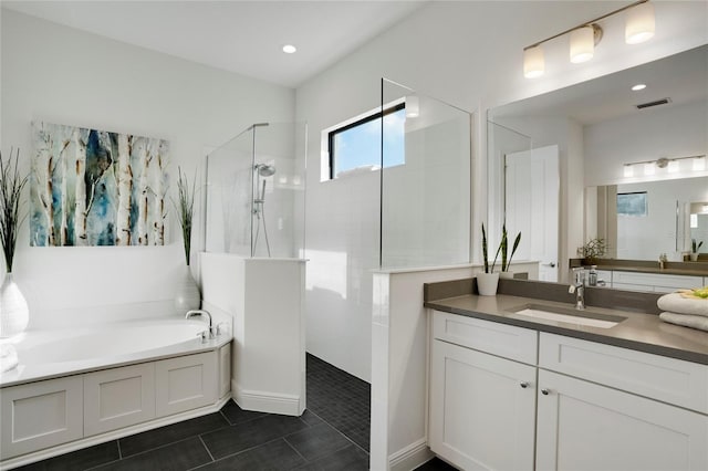 bathroom with tile patterned flooring, vanity, and separate shower and tub