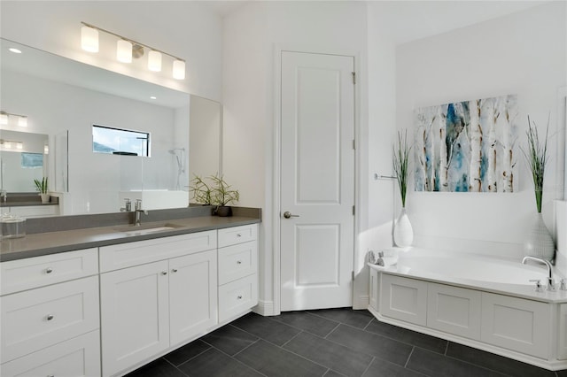 bathroom featuring a tub to relax in, tile patterned flooring, and vanity