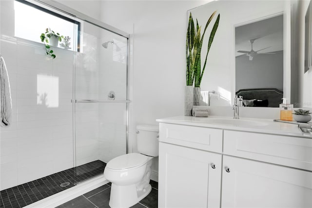 bathroom featuring vanity, tile patterned floors, ceiling fan, toilet, and walk in shower