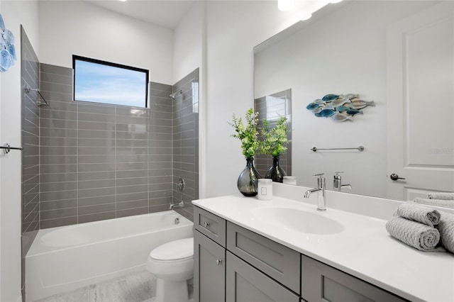 full bathroom featuring vanity, toilet, and tiled shower / bath