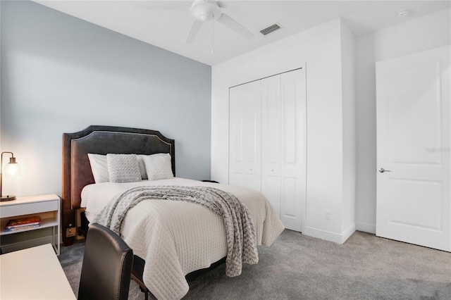 carpeted bedroom featuring ceiling fan and a closet