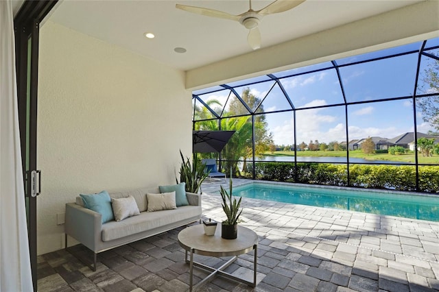 view of swimming pool featuring outdoor lounge area, a water view, a patio, and glass enclosure