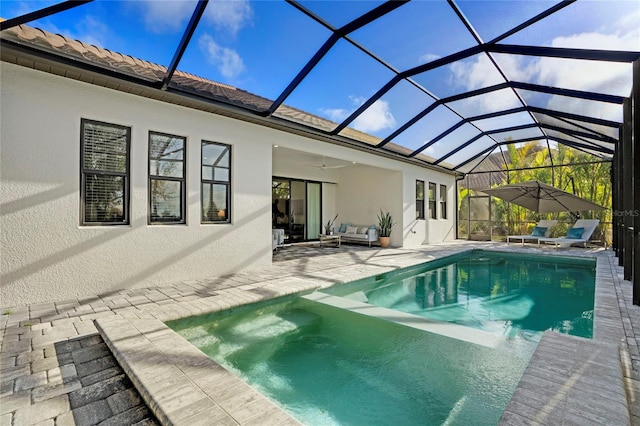 rear view of house with a lanai, a patio area, ceiling fan, and an outdoor hangout area