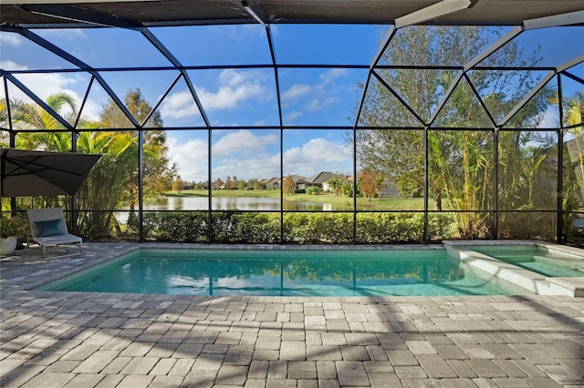 view of pool with a lanai, a patio area, an in ground hot tub, and a water view