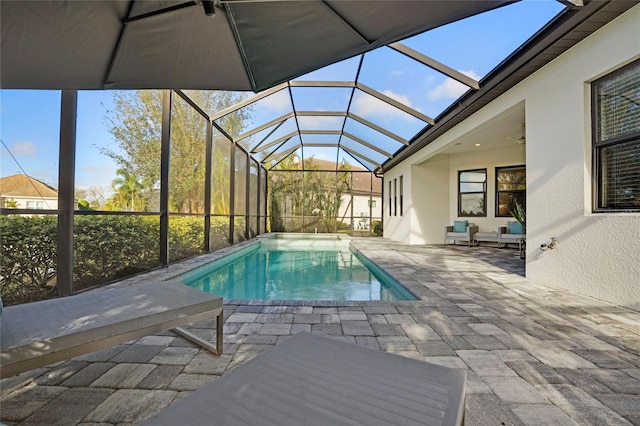 view of swimming pool featuring a patio area and a lanai