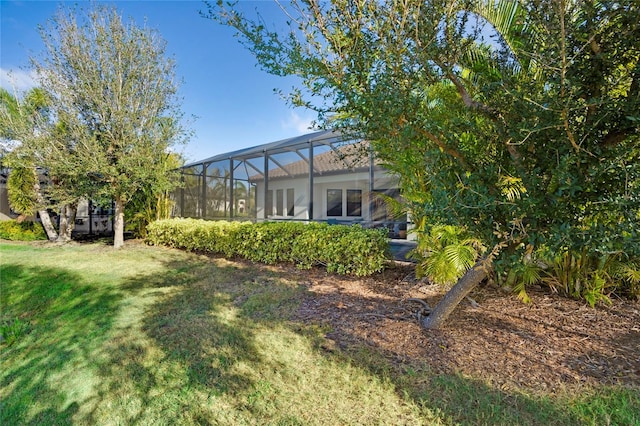 view of yard featuring glass enclosure