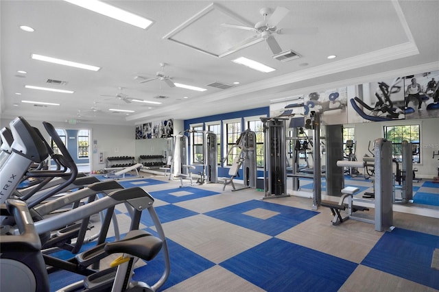 exercise room featuring crown molding, plenty of natural light, ceiling fan, and light carpet