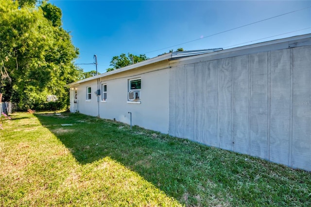 view of home's exterior featuring a lawn and cooling unit