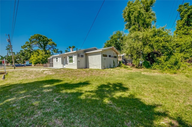 back of house featuring a lawn