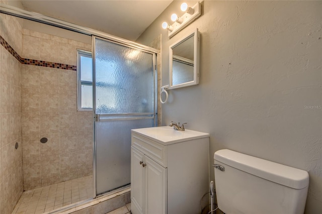 bathroom featuring vanity, toilet, and walk in shower