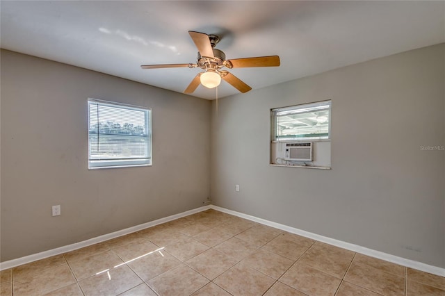 spare room featuring ceiling fan, cooling unit, and light tile patterned floors